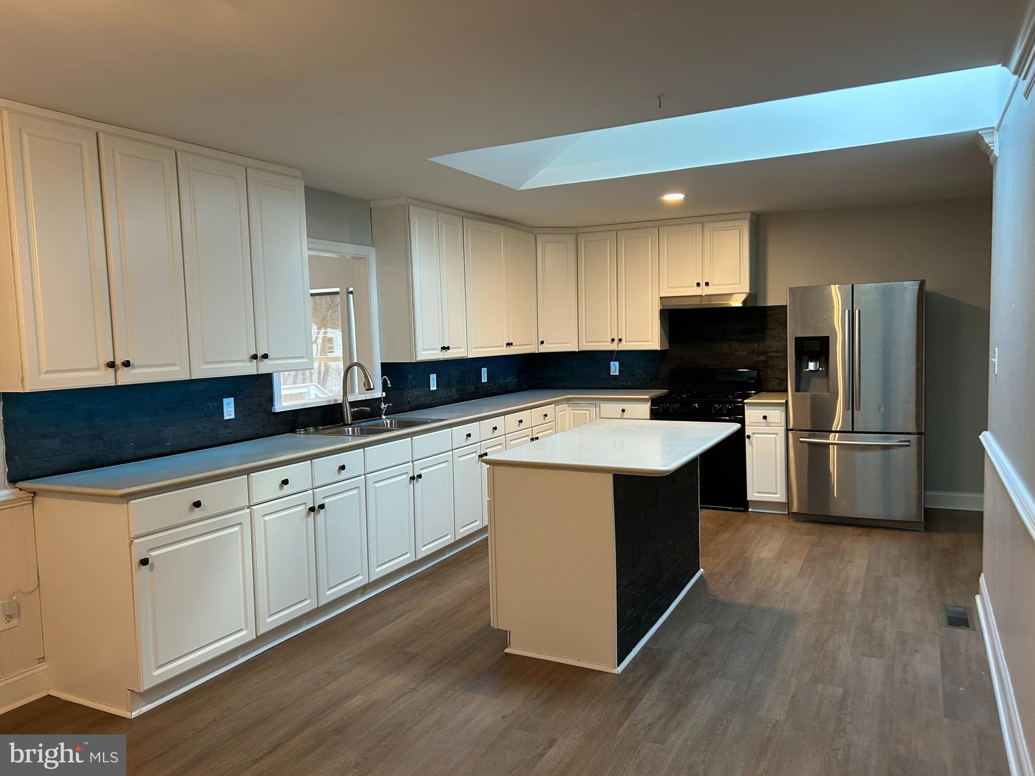 136 Cedar Knoll Road Coatesville, PA 19320 - Photo 7 of 28 a kitchen with wooden cabinets sink and stainless steel appliances