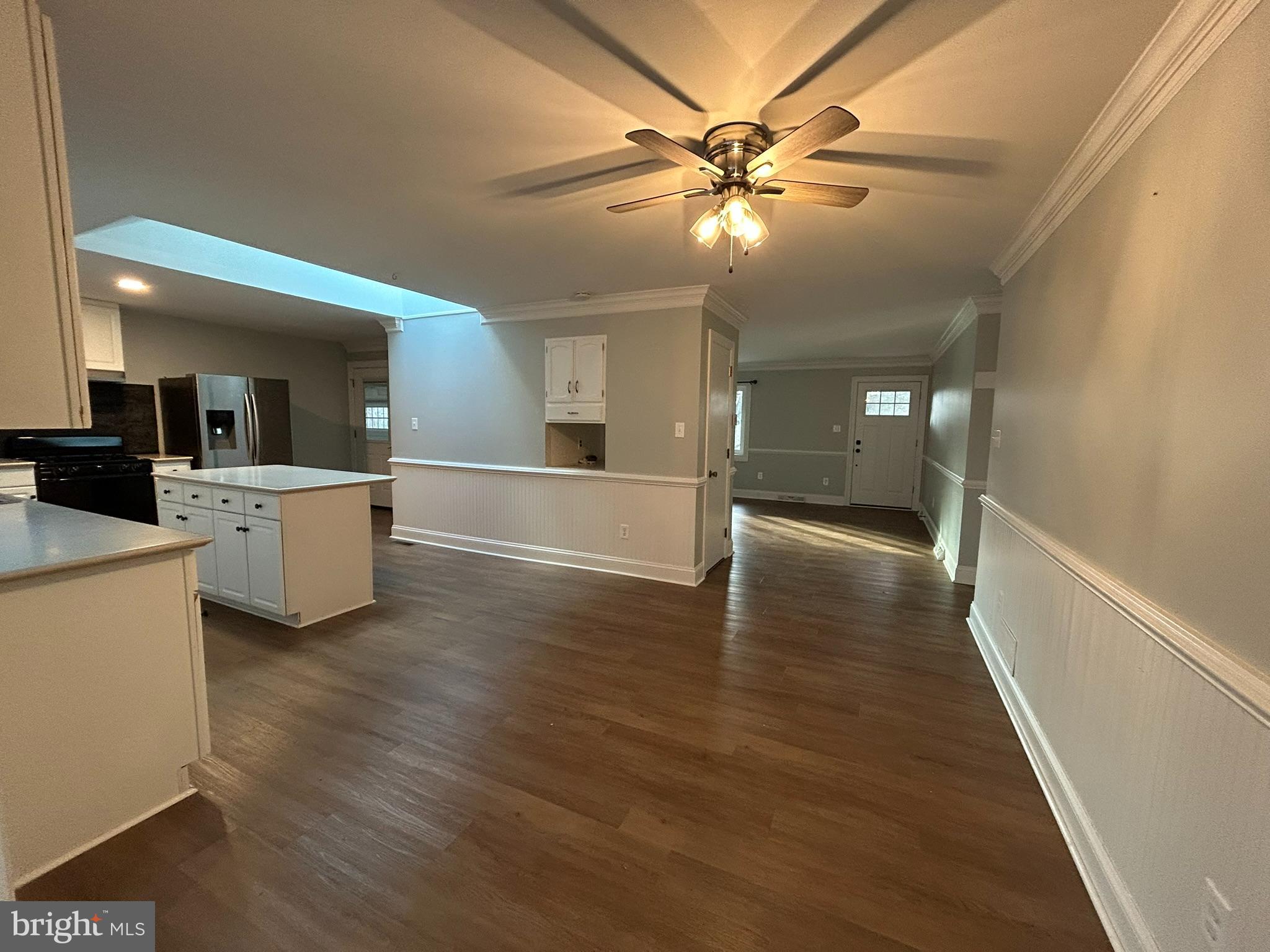 136 Cedar Knoll Road Coatesville, PA 19320 - Photo 10 of 28 an empty room with wooden floor and way to kitchen