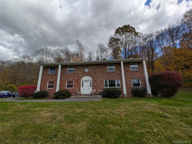 a front view of house with yard and green space