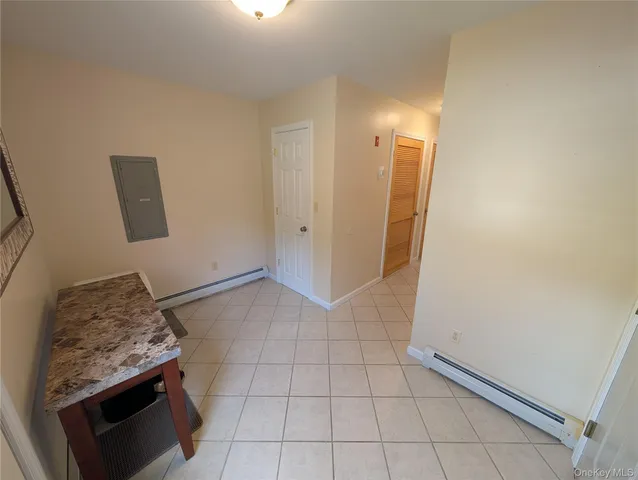 a view of an empty room and wooden floor