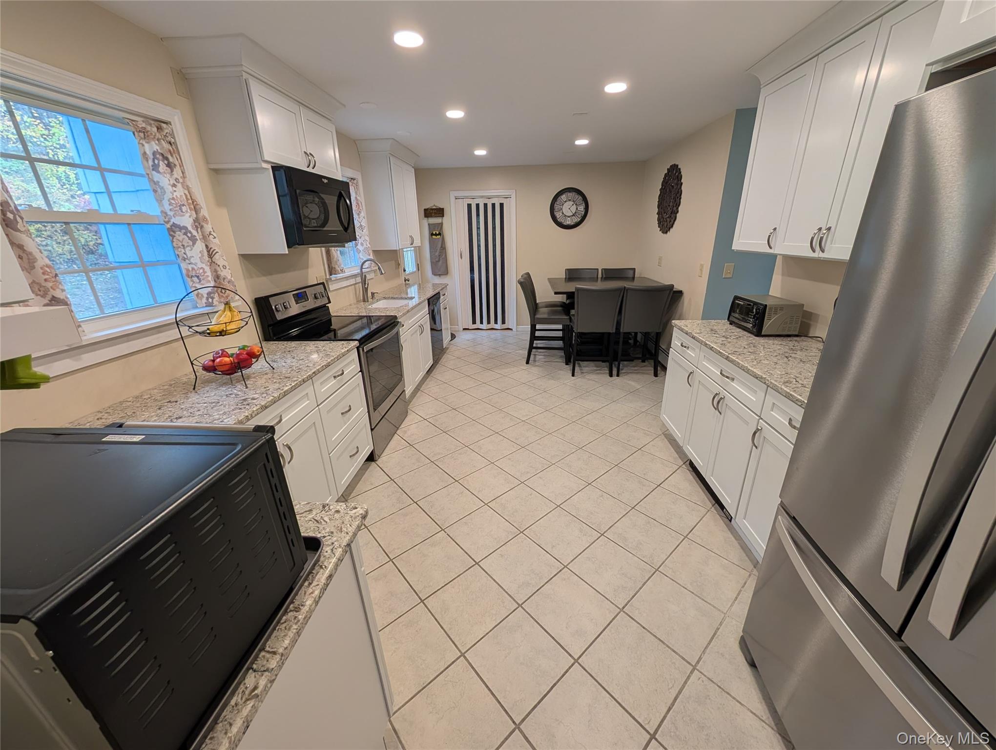 5 Equestrian Acres Lane Brewster, NY 10509 - Photo 12 of 50 a kitchen with stainless steel appliances a refrigerator sink and microwave