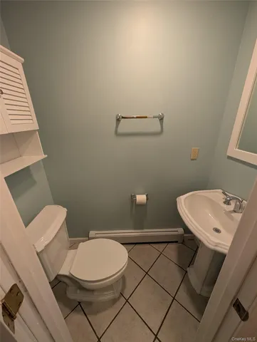 a white toilet sitting next to a white sink