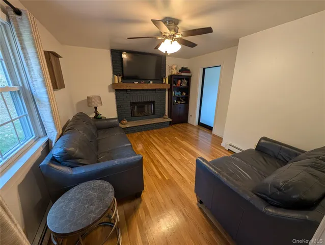 a living room with furniture a flat screen tv and a fireplace
