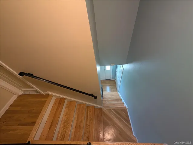 a view of a room with wooden floor