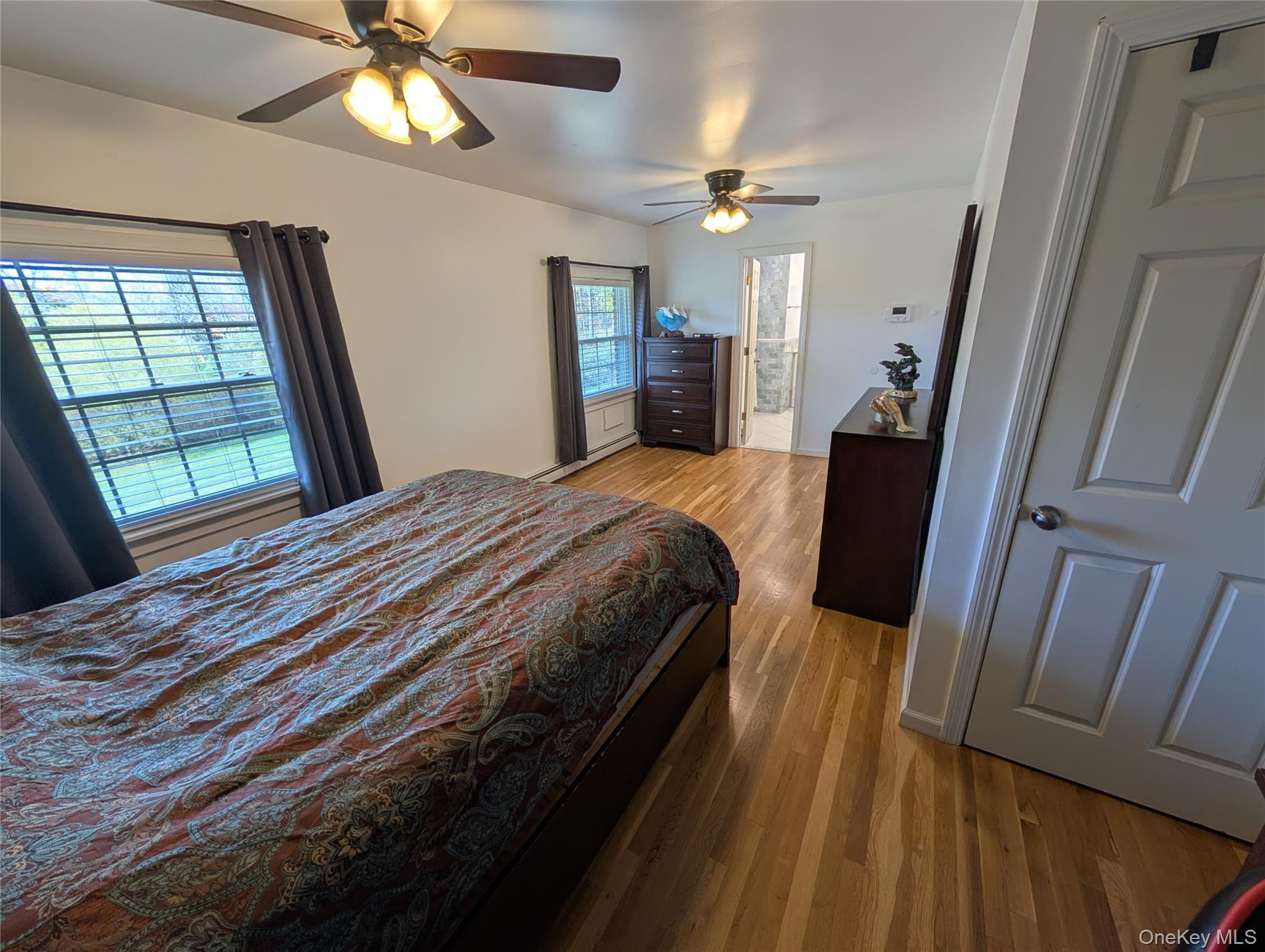 5 Equestrian Acres Lane Brewster, NY 10509 - Photo 24 of 50 a bedroom with a bed and a large mirror with wooden floor