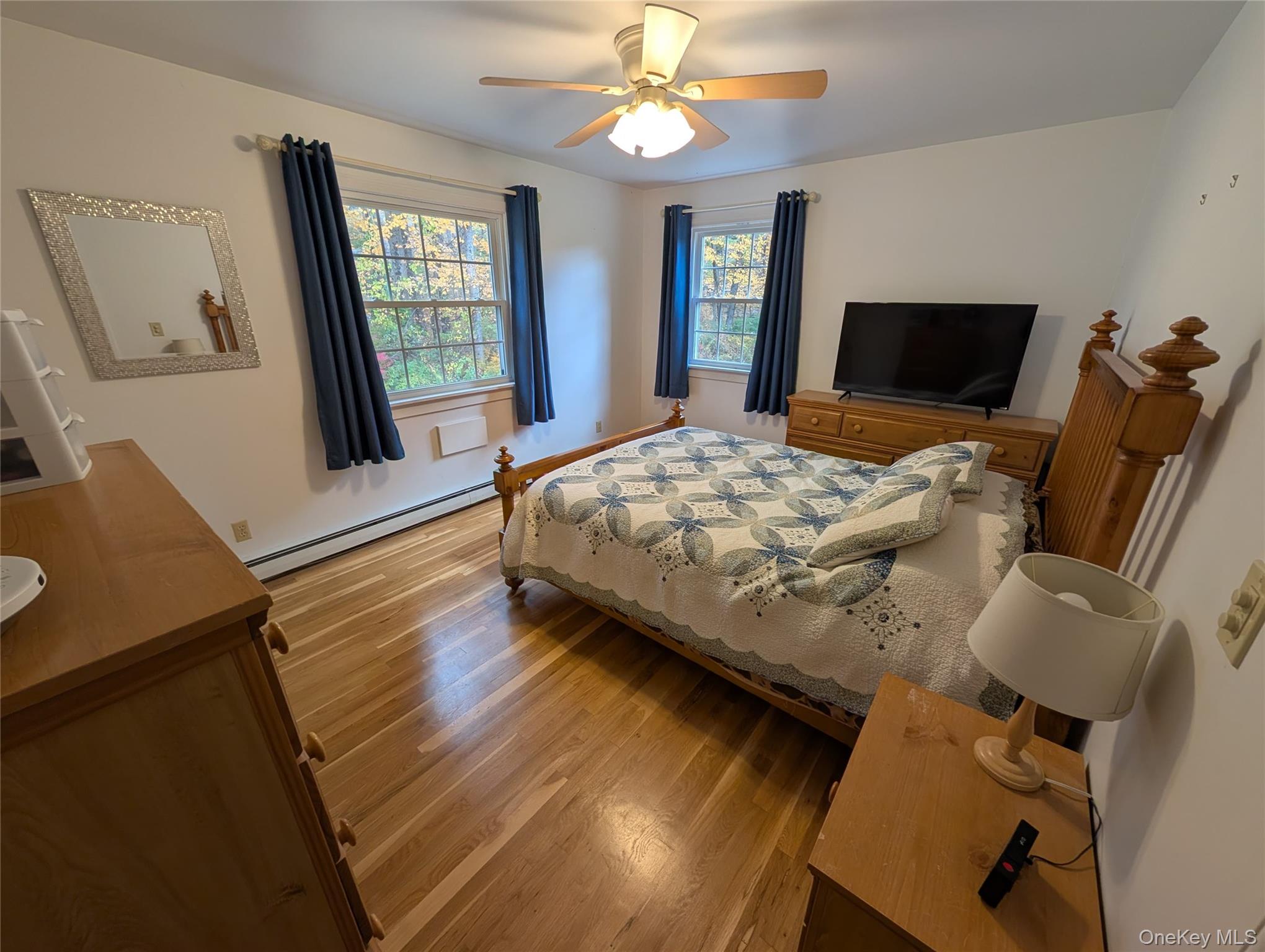 5 Equestrian Acres Lane Brewster, NY 10509 - Photo 29 of 50 a bedroom with a bed and wooden floor