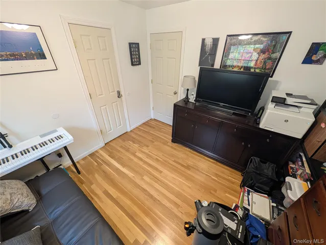 a bedroom with a bed and flat screen tv