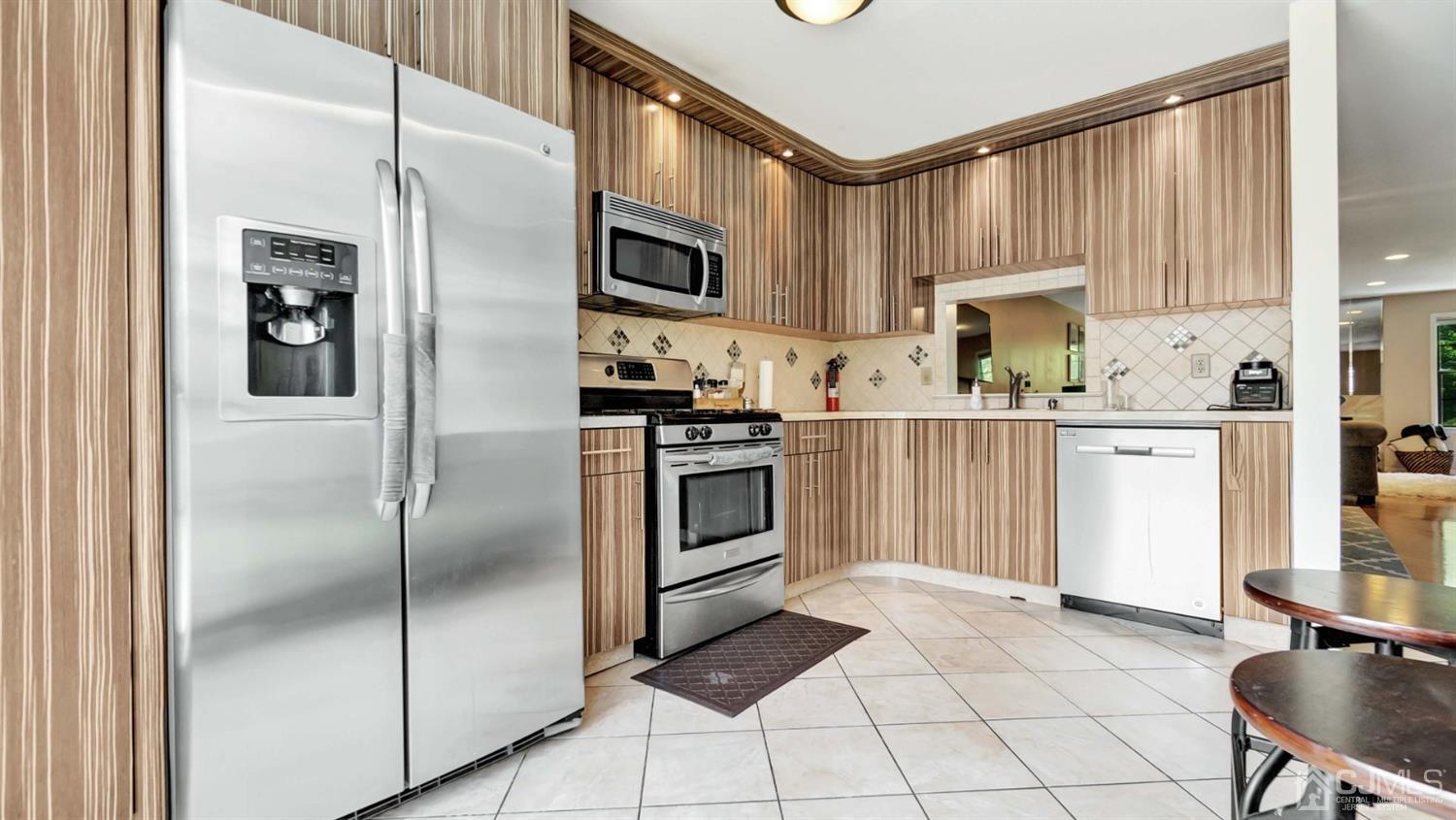 3404 Springbrook Drive Edison, NJ 08820 - Photo 12 of 32 a kitchen with stainless steel appliances a refrigerator sink and cabinets