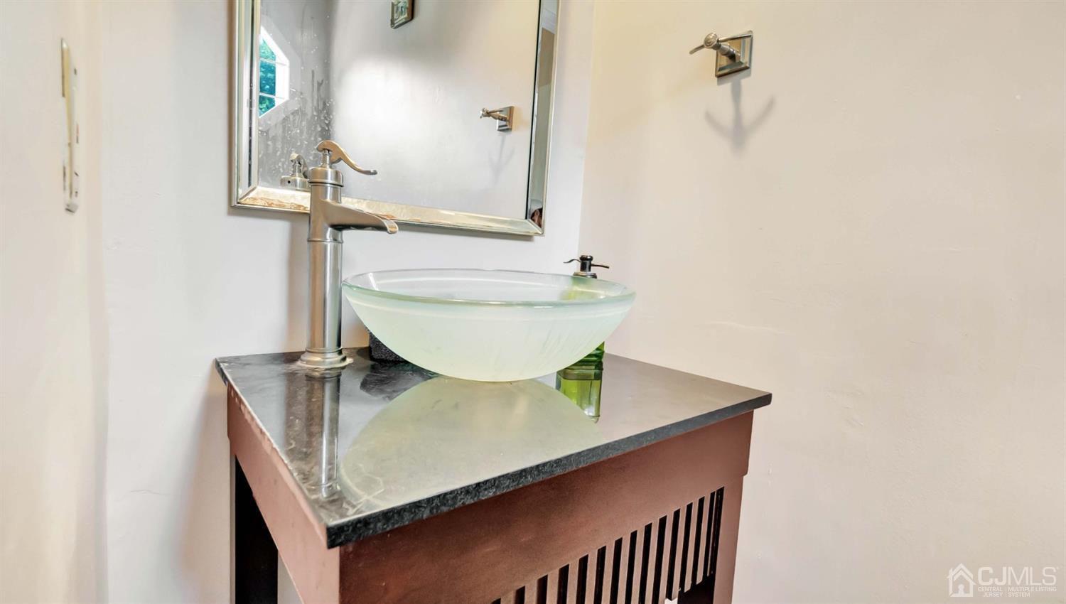 3404 Springbrook Drive Edison, NJ 08820 - Photo 16 of 32 a bathroom with a sink a mirror and vanity