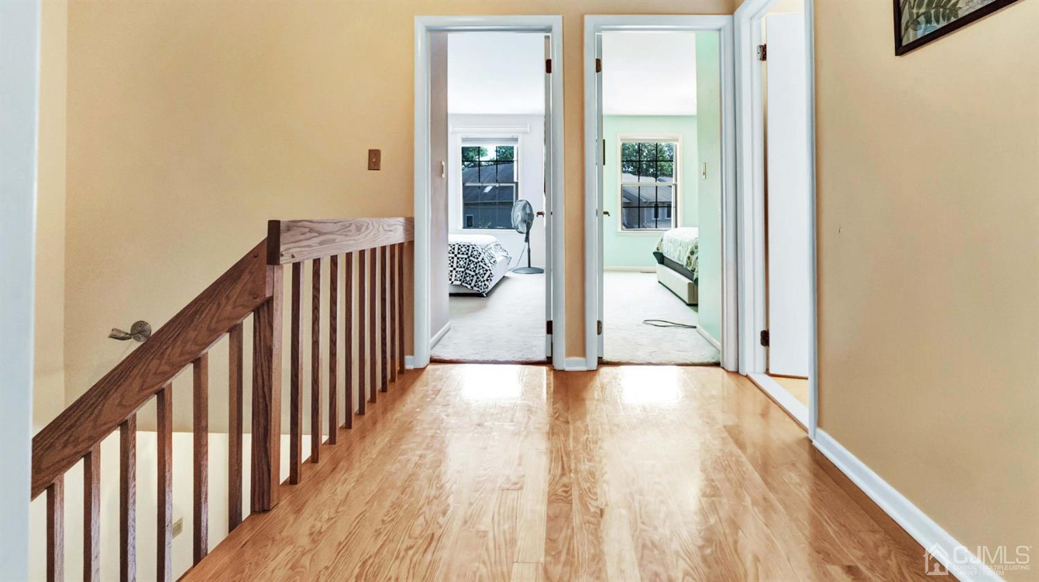 3404 Springbrook Drive Edison, NJ 08820 - Photo 18 of 32 a view of a hallway with wooden floor and stairs