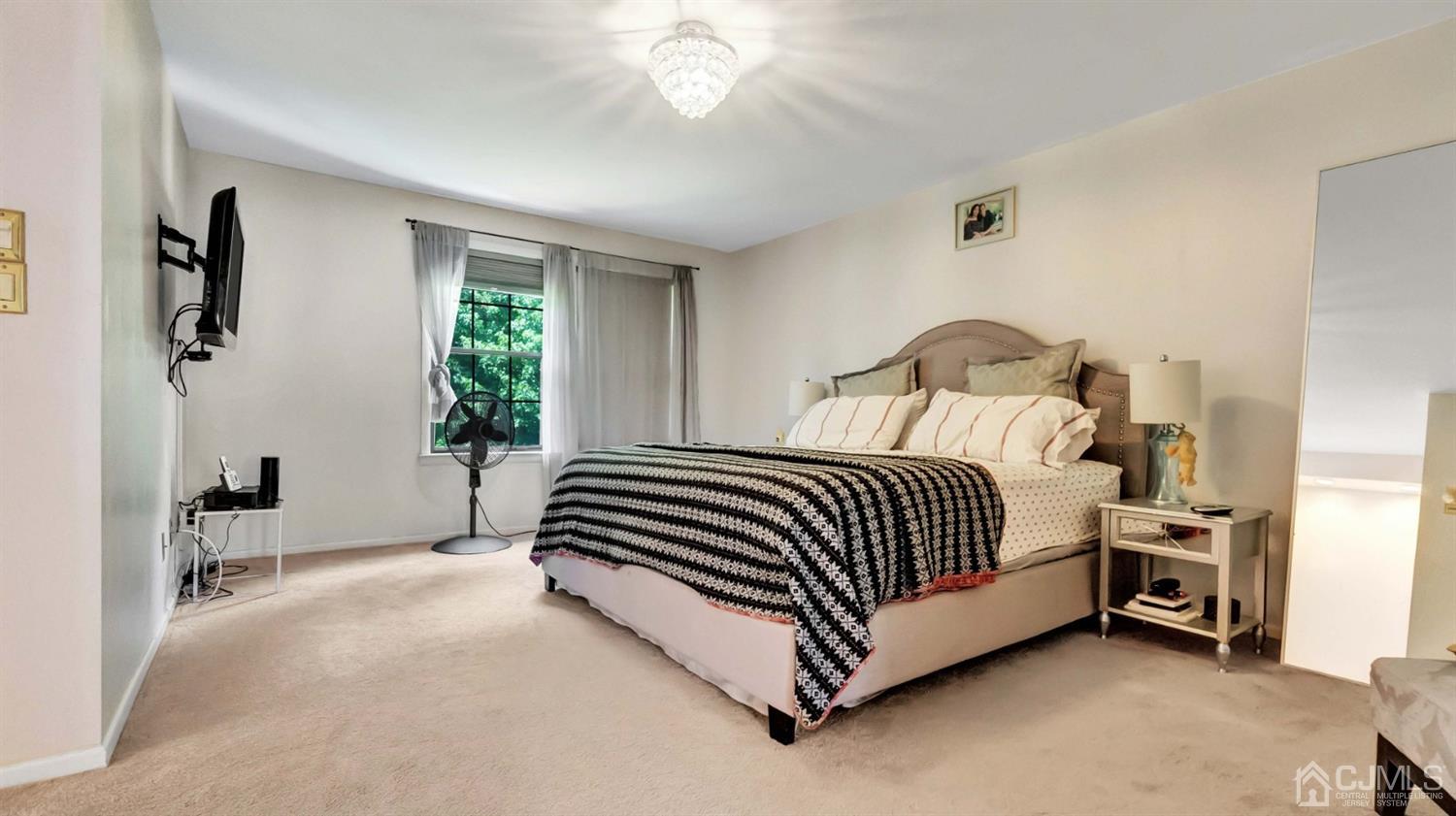 3404 Springbrook Drive Edison, NJ 08820 - Photo 20 of 32 a bed sitting in a bedroom next to a window and a chair