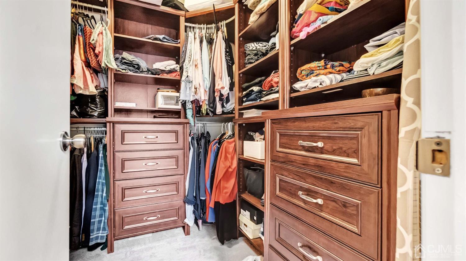 3404 Springbrook Drive Edison, NJ 08820 - Photo 21 of 32 a view of walk in closet with clothes and shoes