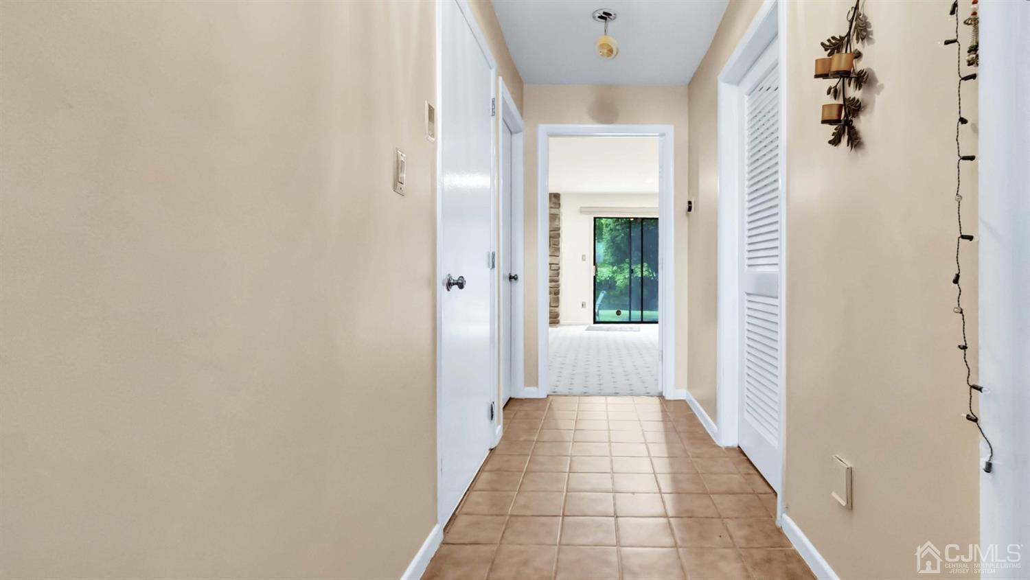 3404 Springbrook Drive Edison, NJ 08820 - Photo 26 of 32 a view of a hallway with white walls and a window