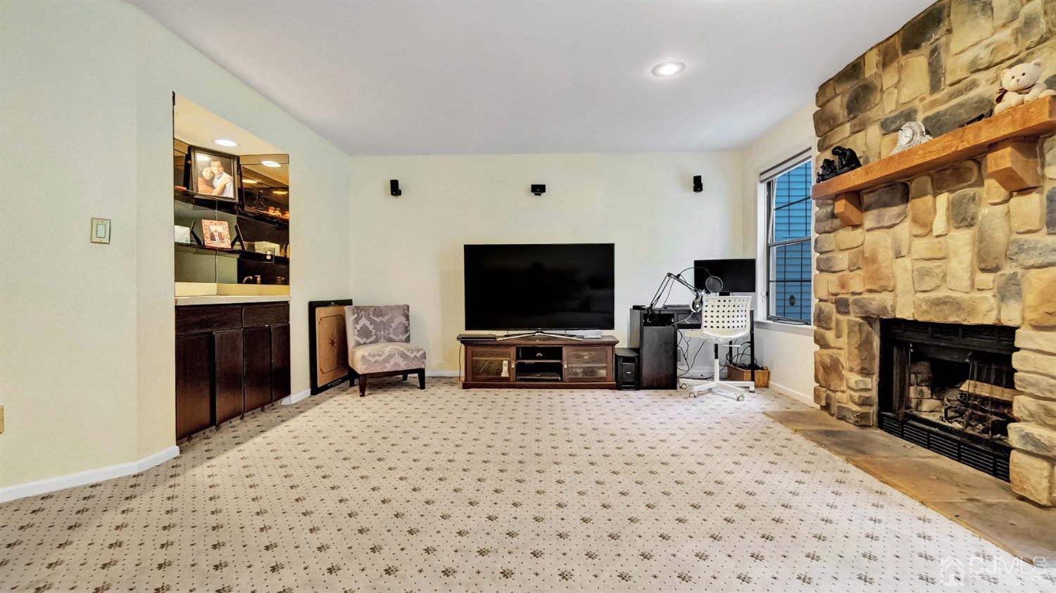 3404 Springbrook Drive Edison, NJ 08820 - Photo 28 of 32 a living room with furniture a flat screen tv and a fireplace