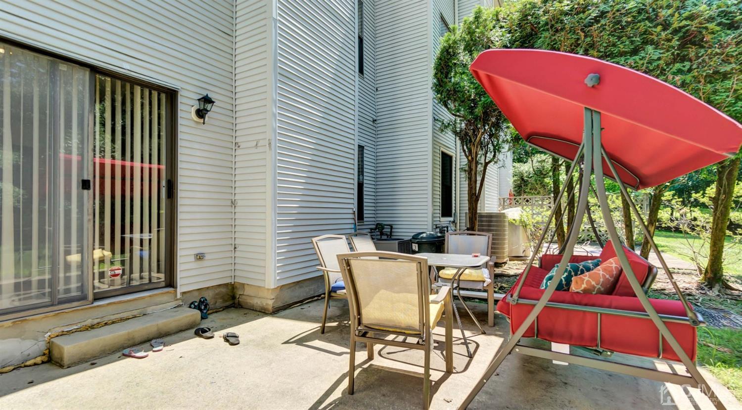 3404 Springbrook Drive Edison, NJ 08820 - Photo 31 of 32 a view of a patio with table and chairs under an umbrella
