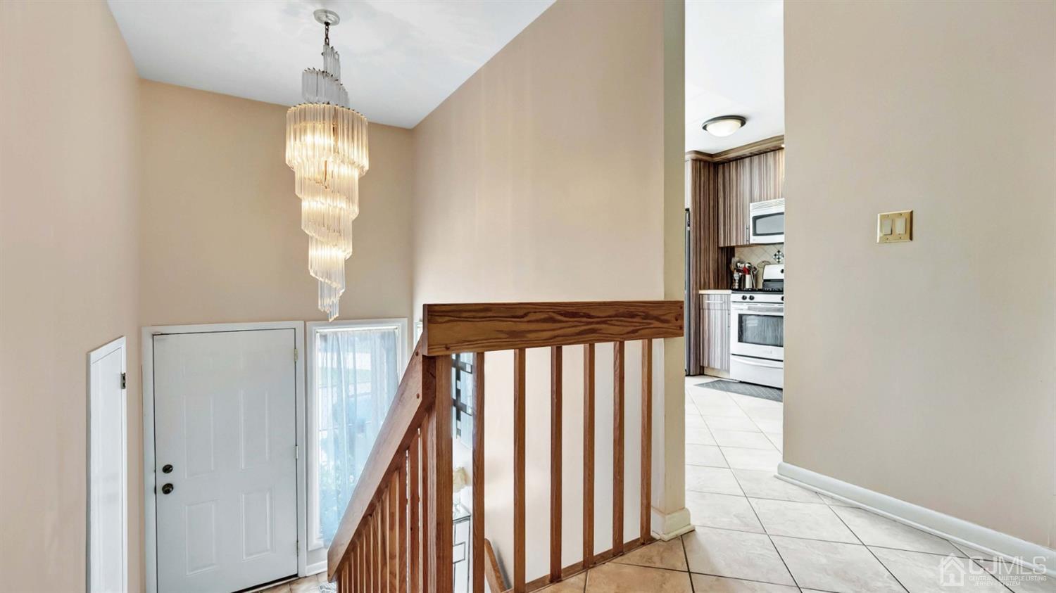 3404 Springbrook Drive Edison, NJ 08820 - Photo 10 of 32 a view of a hallway with wooden floor and staircase