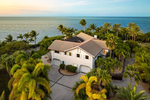 an aerial view of a house with a ocean view