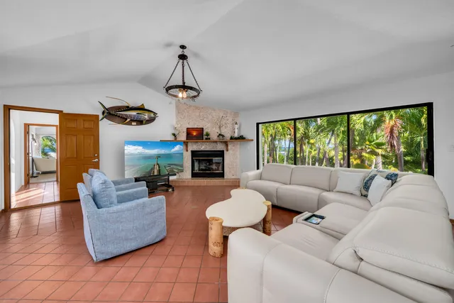 a spacious bathroom with a double vanity sink a toilet mirror and shower