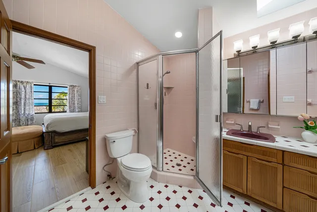 a bedroom with a bed and a large mirror