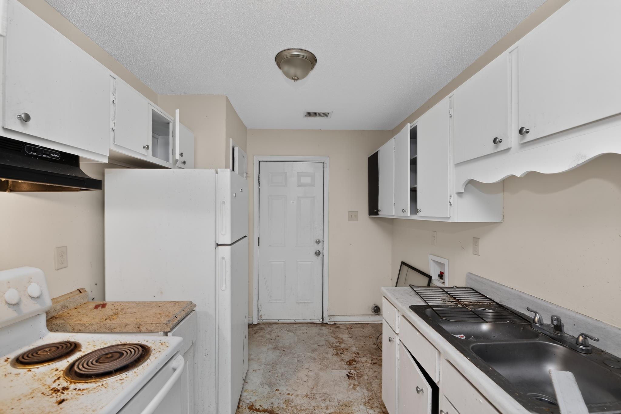 3953 McCain Road Memphis, TN 38109 - Photo 8 of 15 Kitchen space featuring white cabinetry, a single-bowl sink, and a rear exterior door