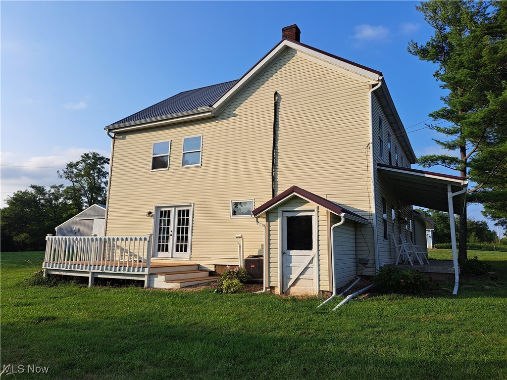 49197 John Tomcho Road Cumberland, OH 43732 - Photo 6 of 50 Side of house featuring a wooden deck, french doors, and a yard