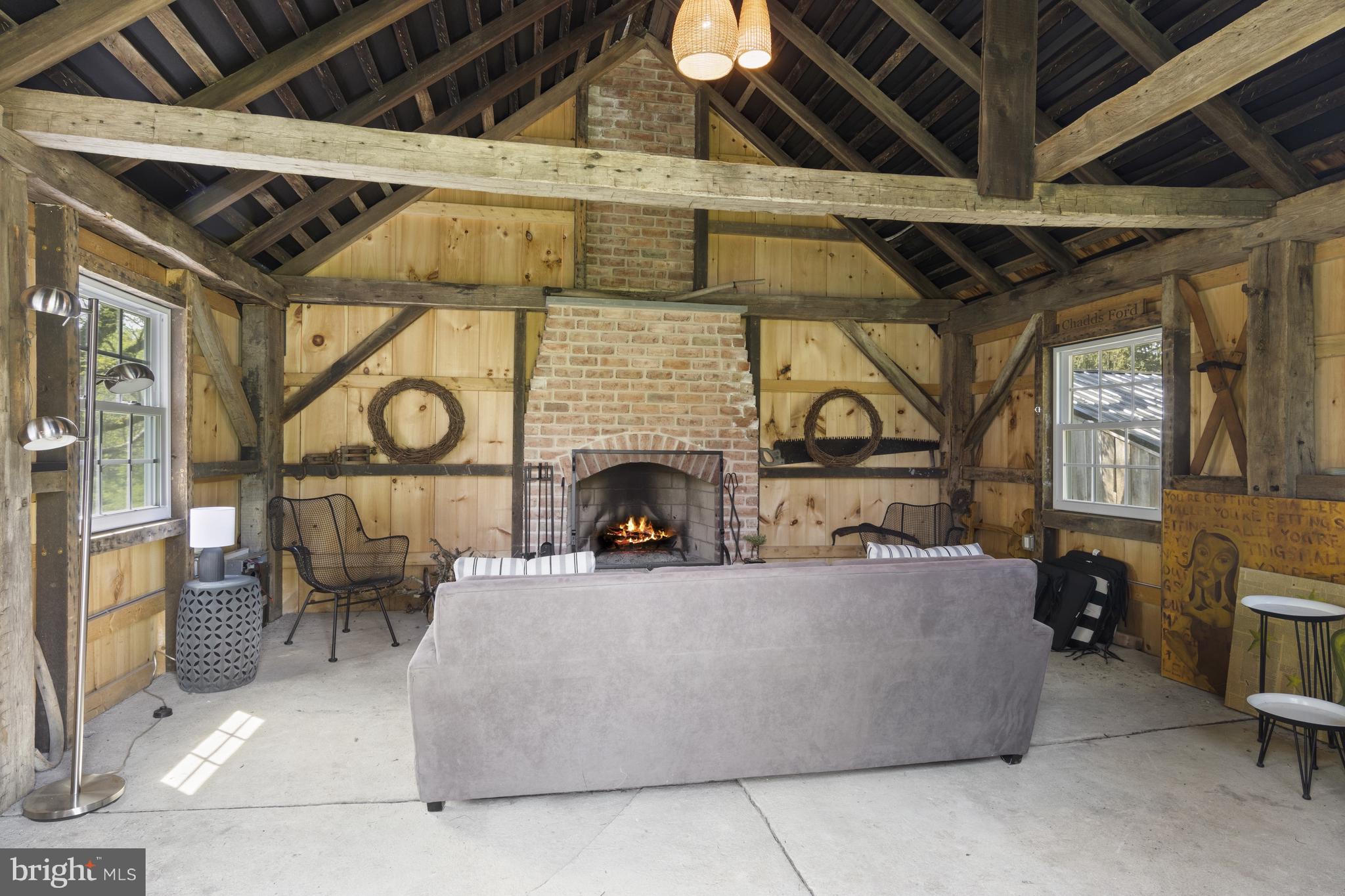 1250 Hillendale Road Chadds Ford, PA 19317 - Photo 71 of 76 a living room with furniture a fireplace and a table