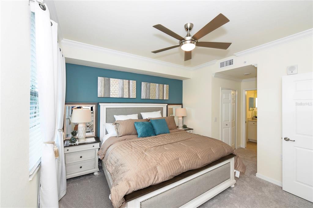 17810 Gawthrop Drive, Unit 101 Lakewood Ranch, FL 34211 - Photo 12 of 53 a bedroom with a large bed and a chandelier
