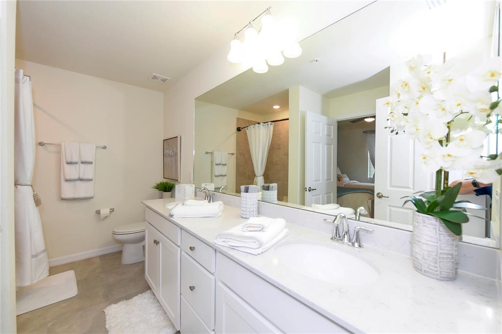 17810 Gawthrop Drive, Unit 101 Lakewood Ranch, FL 34211 - Photo 21 of 53 a bathroom with a granite countertop sink mirror and a toilet