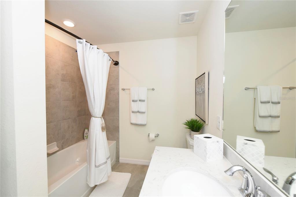 17810 Gawthrop Drive, Unit 101 Lakewood Ranch, FL 34211 - Photo 22 of 53 a bathroom with a bathtub and shower
