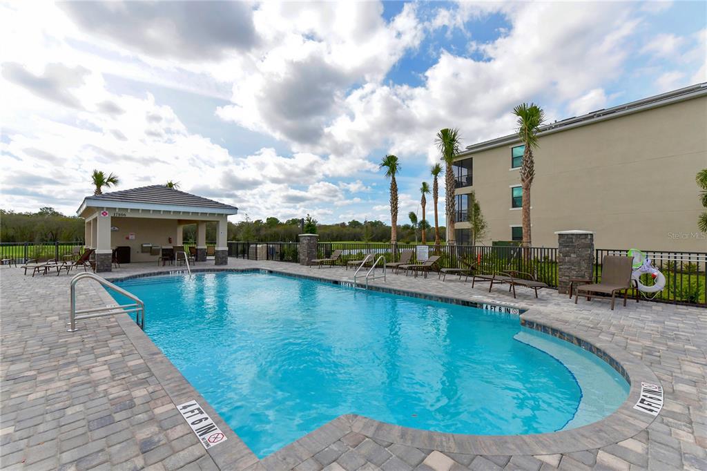 17810 Gawthrop Drive, Unit 101 Lakewood Ranch, FL 34211 - Photo 34 of 53 a swimming pool with outdoor seating and yard