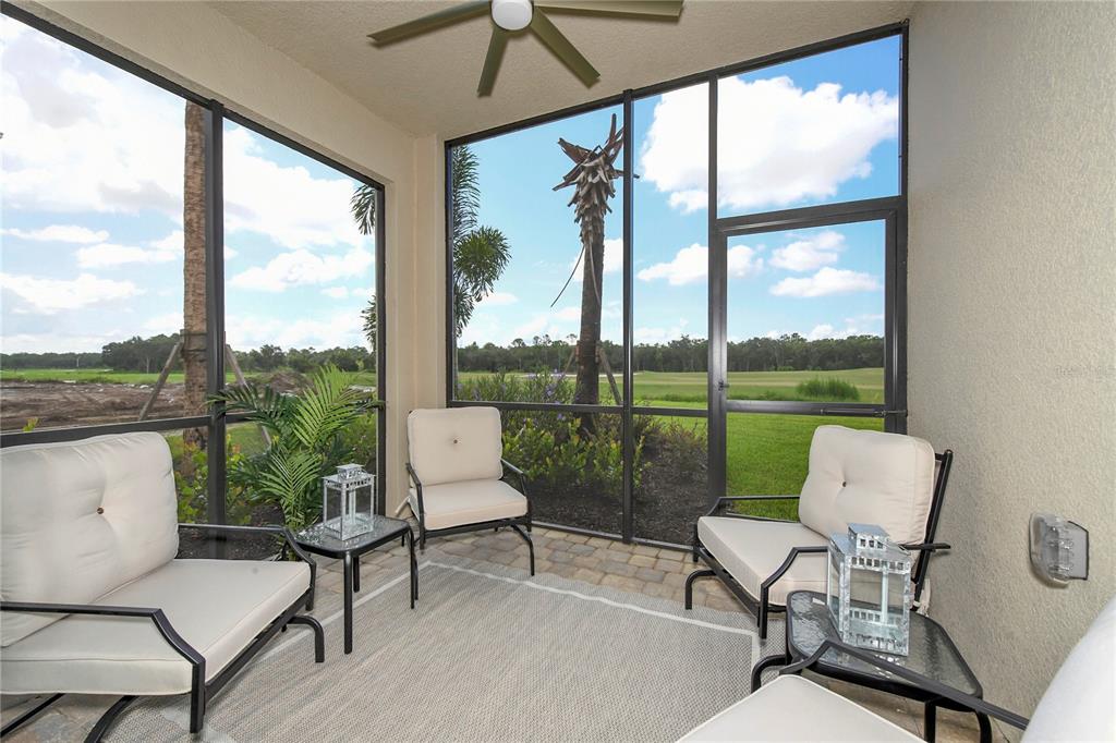 17810 Gawthrop Drive, Unit 101 Lakewood Ranch, FL 34211 - Photo 10 of 53 a living room with patio area and garden view