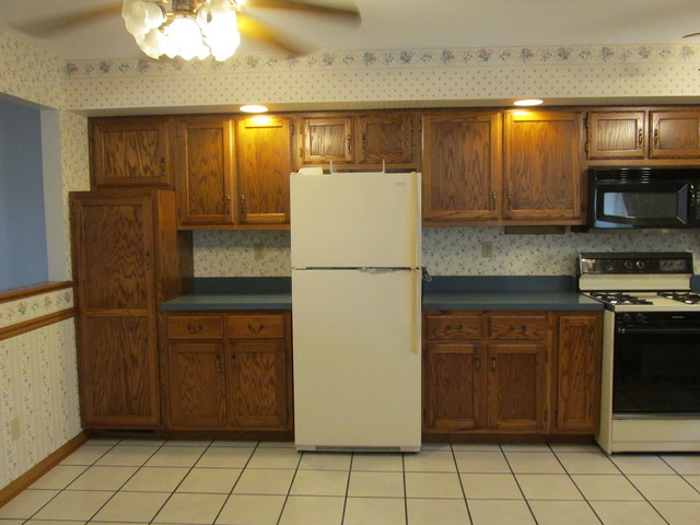 708 South Cooper Road New Lenox, IL 60451 - Photo 2 of 24 a kitchen with stainless steel appliances granite countertop a refrigerator and a stove