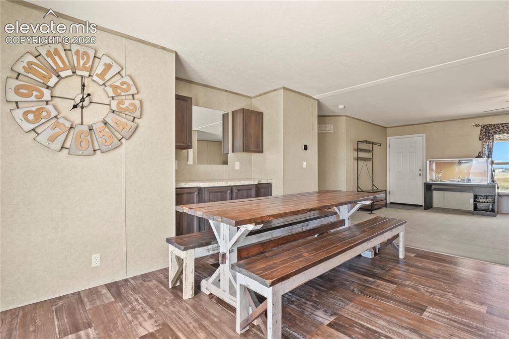 22280 Jones Road Peyton, CO 80831 - Photo 10 of 47 a living room with a table and a chair