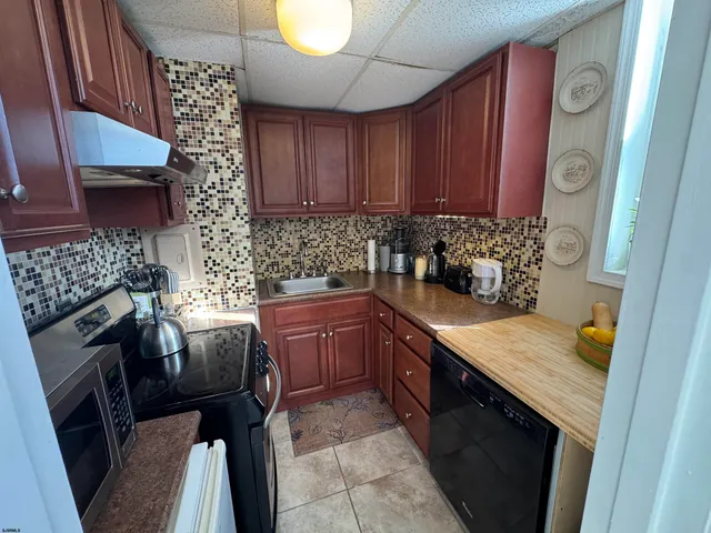 a living room with furniture a chandelier and a flat screen tv