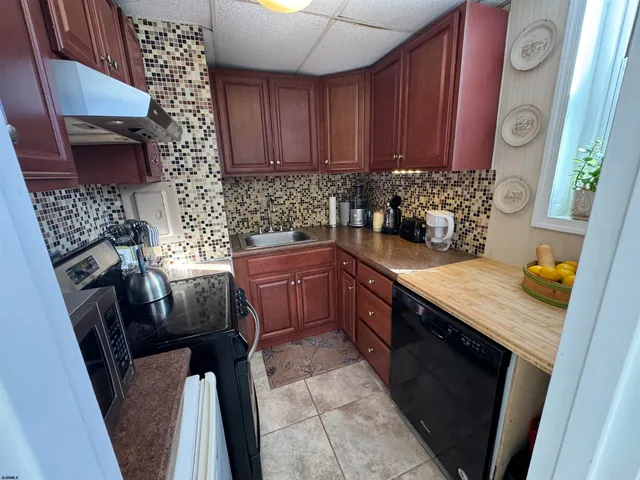 a livingroom with furniture a floor to ceiling window and a fireplace