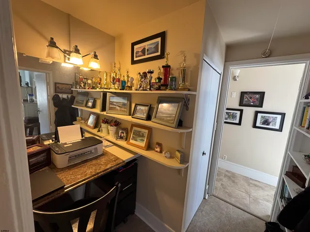 a view of a room with a table and chairs