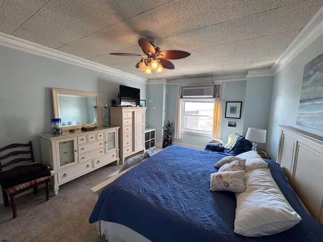 a bedroom with furniture and a flat screen tv