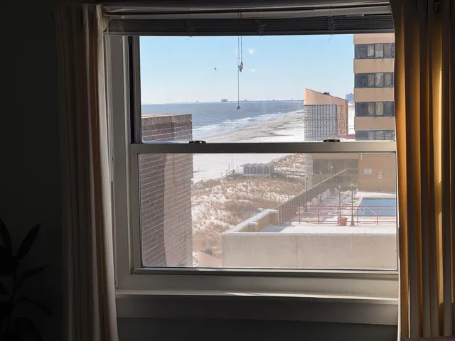 a bedroom with a bed window and couch