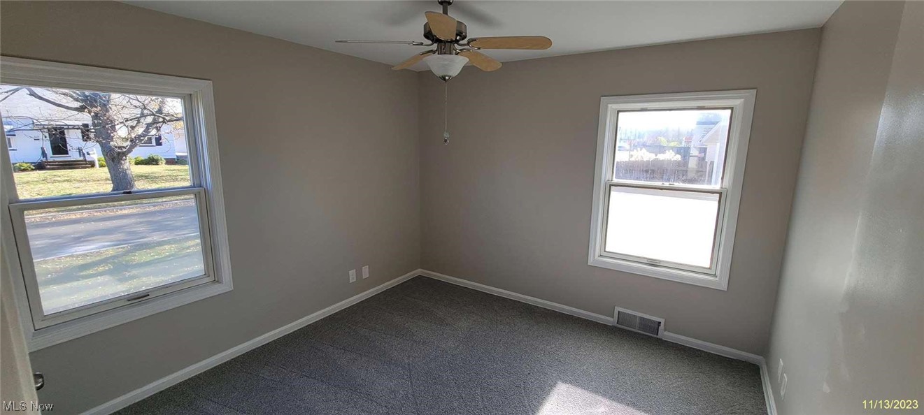 6149 North Canterbury Road Parma, OH 44129 - Photo 5 of 16 Unfurnished room featuring dark carpet and ceiling fan