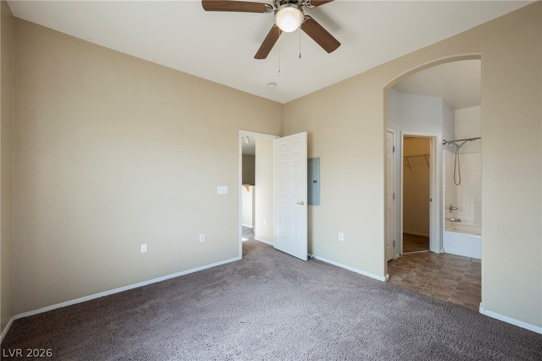 6320 Snap Ridge Street, Unit 201 North Las Vegas, NV 89081 - Photo 27 of 56 A well-lit bedroom features plush carpeting and a convenient ceiling fan for ultimate comfort.