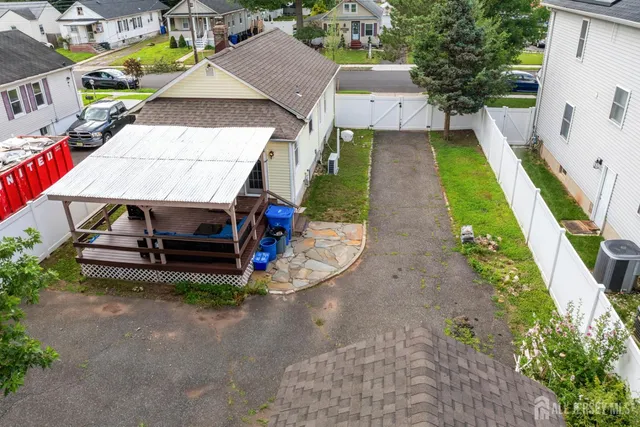 an aerial view of a house with swimming pool garden and patio