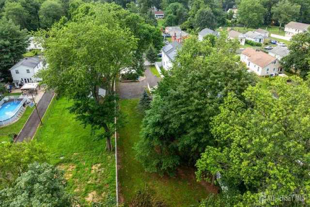 an aerial view of residential houses with outdoor space and street view