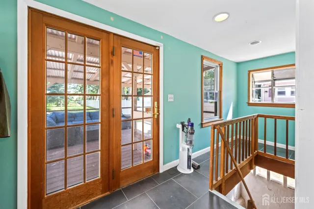 a view of a room with wooden floor and windows