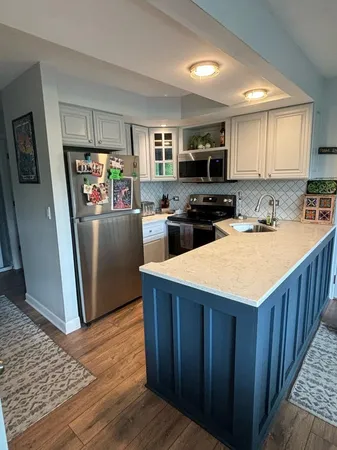 a kitchen with refrigerator cabinets and wooden floor