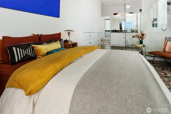 a spacious bedroom with a bed couch and a window