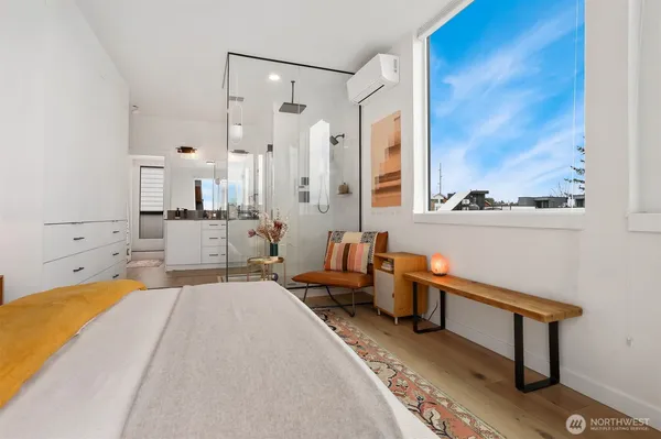 a bedroom with a bed and glass window