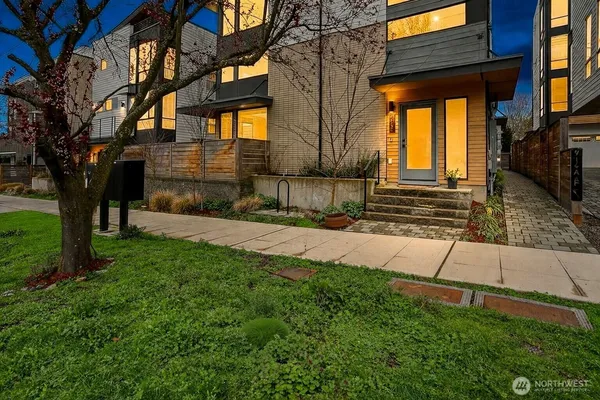 a view of a house with a yard and pathway