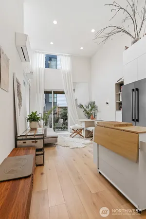 a living room with stainless steel appliances kitchen island granite countertop furniture and a view of living room