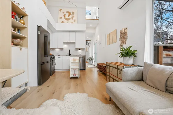 a living room with furniture and view of kitchen