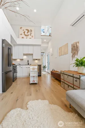a living room with stainless steel appliances kitchen island furniture and a kitchen view